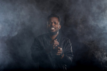 Young handsome african american man dancing in dark