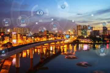 Digital network connection lines of Hanoi city, Vietnam. Smart city in technology concept. Skyscraper and high-rise buildings. Aerial view at Hoang Cau lake at night