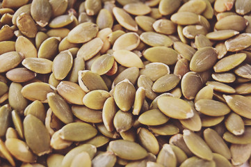 Raw pumpkin seeds background.