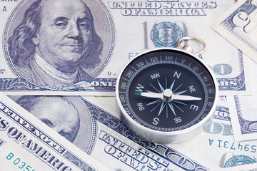 Financial Concept : US Dollar and Compass.