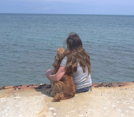 girl with a dog near the sea