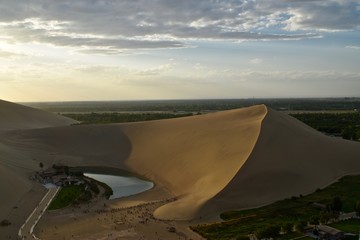 Yueyaquan lake (Crescent moon lake) in a small oasis during sunset close to Dunhuang, Gansu province, China. 