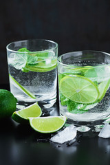 Coctail with lime and mint on dark background