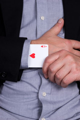 Card ace of hearts in the black sleeve of the suit