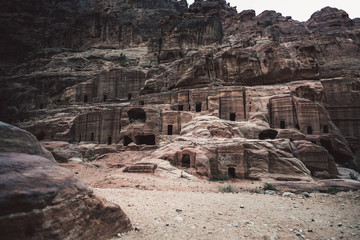 Caves in rocks in desert landscape of Petra, Jordan, Asia
