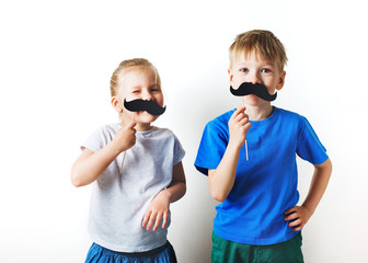 Fathers day concept, two little caucasian kids with moustache on white background