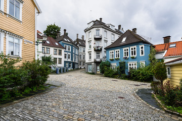 A cozy cobbled square in Bergen surrounded by colorful wooden houses, Norway