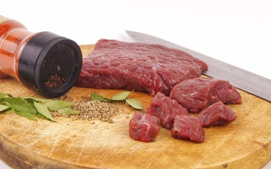 Fresh raw beef meat on cutting board with herbs and spices