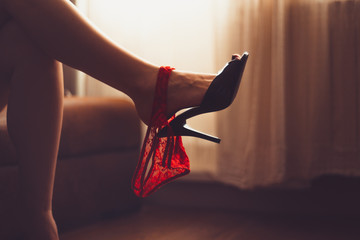 sexy woman legs in high heel mules. women fetish shoe dangling on feet. shoeplay, shoe and foot...
