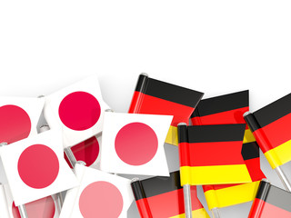 Pins with flags of Japan and germany isolated on white.
