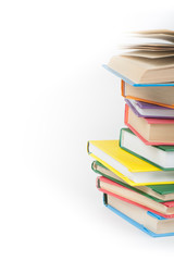 Book stacking. Open book, hardback books on white background. Back to school. Copy space for text.