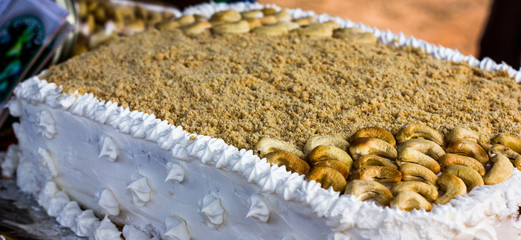 Cashew nut cake with crushed cashew nuts and frosting