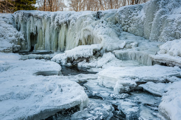 Famous waterfall in Estonia. Keila-Joa Schloss Fall. Partly frozen waterfall by winter. Estonia.
