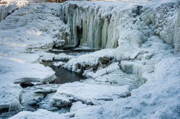 Famous waterfall in Estonia. Keila-Joa Schloss Fall. Partly frozen waterfall by winter. Estonia.