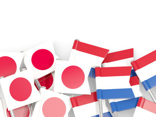 Pins with flags of Japan and netherlands isolated on white.