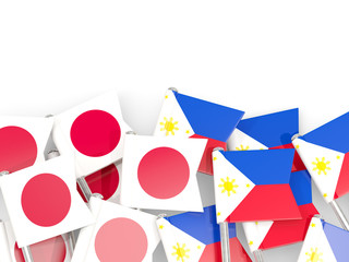 Pins with flags of Japan and philippines isolated on white.