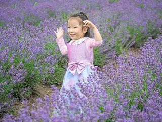 Little Chinese baby posing in beautiful purple lavender field, beautiful young girl with lovely braid, happy children lifestyle.