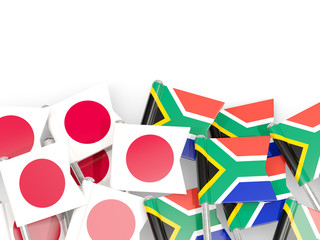 Pins with flags of Japan and south africa isolated on white.