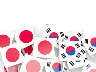 Pins with flags of Japan and south korea isolated on white.