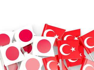 Pins with flags of Japan and turkey isolated on white.