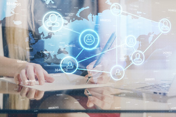 Social network theme hologram over hands taking notes background. Concept of global international people connect. Double exposure