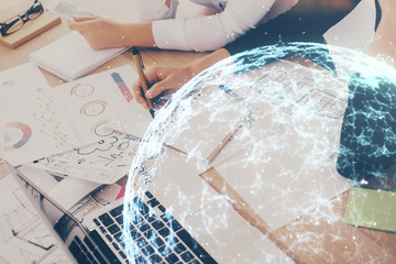 Social network theme hologram over hands taking notes background. Concept of global international people connect. Double exposure