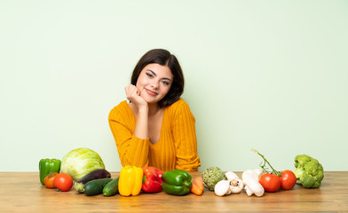 Fototapeta premium Teenager girl with many vegetables laughing