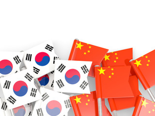 Pins with flags of South Korea and china isolated on white.
