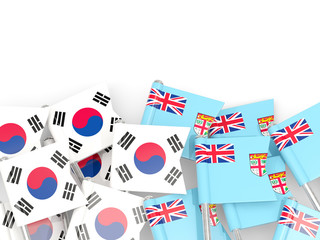 Pins with flags of South Korea and fiji isolated on white.