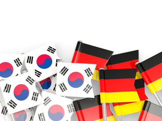 Pins with flags of South Korea and germany isolated on white.
