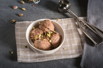 Bowl of chocolate ice cream on rustic background