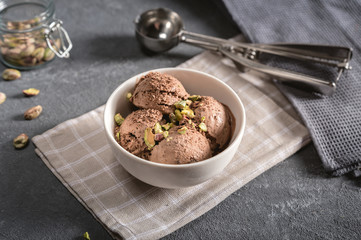 Bowl of chocolate ice cream on rustic background