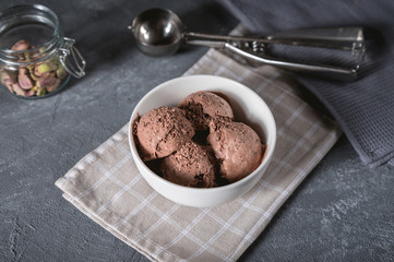 Bowl of chocolate ice cream on rustic background