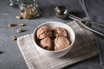 Bowl of chocolate ice cream on rustic background