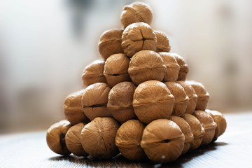 Pyramid of walnuts. Closeup view from side. Macrophotography.