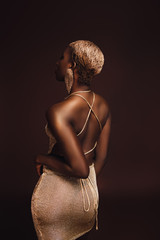 back view of young glamorous african american woman with short hair isolated on brown