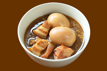 Hard boiled egg or Golden brown egg with five spices egg isolated on brown background. This image with clipping path for advertising. ideas concept. Traditional thai food..