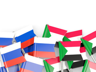 Pins with flags of Russia and sudan isolated on white.