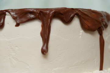 Birthday cake with chocolate syrup. Close-up. Side view.