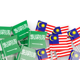 Pins with flags of Saudi Arabia and malaysia isolated on white.