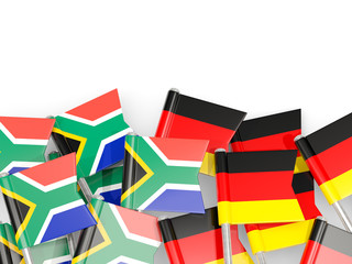Pins with flags of South Africa and germany isolated on white.