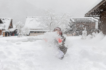 young asian playing snow in the shirakawa go village Osaka japan