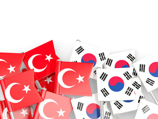 Pins with flags of Turkey and south korea isolated on white.