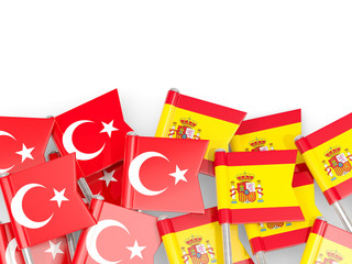 Pins with flags of Turkey and spain isolated on white.