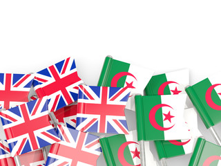 Pins with flags of UK and algeria isolated on white.