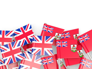 Pins with flags of UK and bermuda isolated on white.