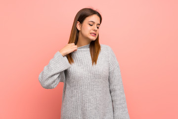 Young woman over pink wall with tired and sick expression