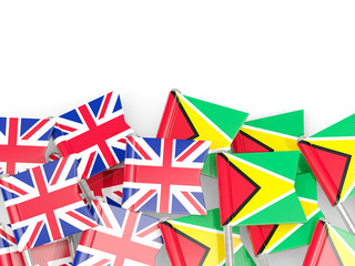 Pins with flags of UK and guyana isolated on white.