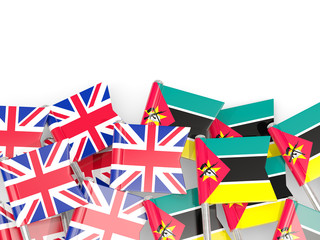 Pins with flags of UK and mozambique isolated on white.