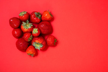 Strawberries on red background